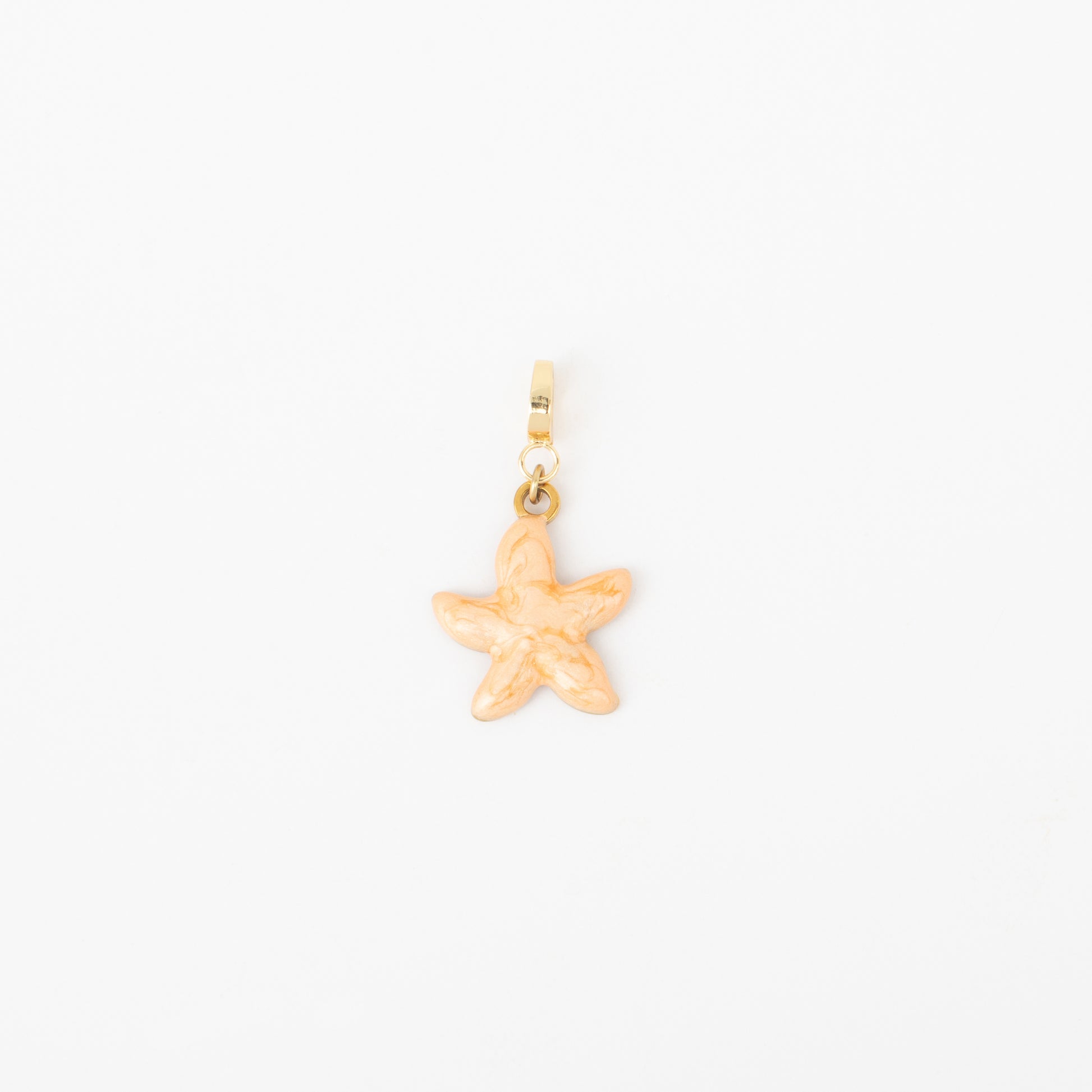 Gold starfish charm on a white background