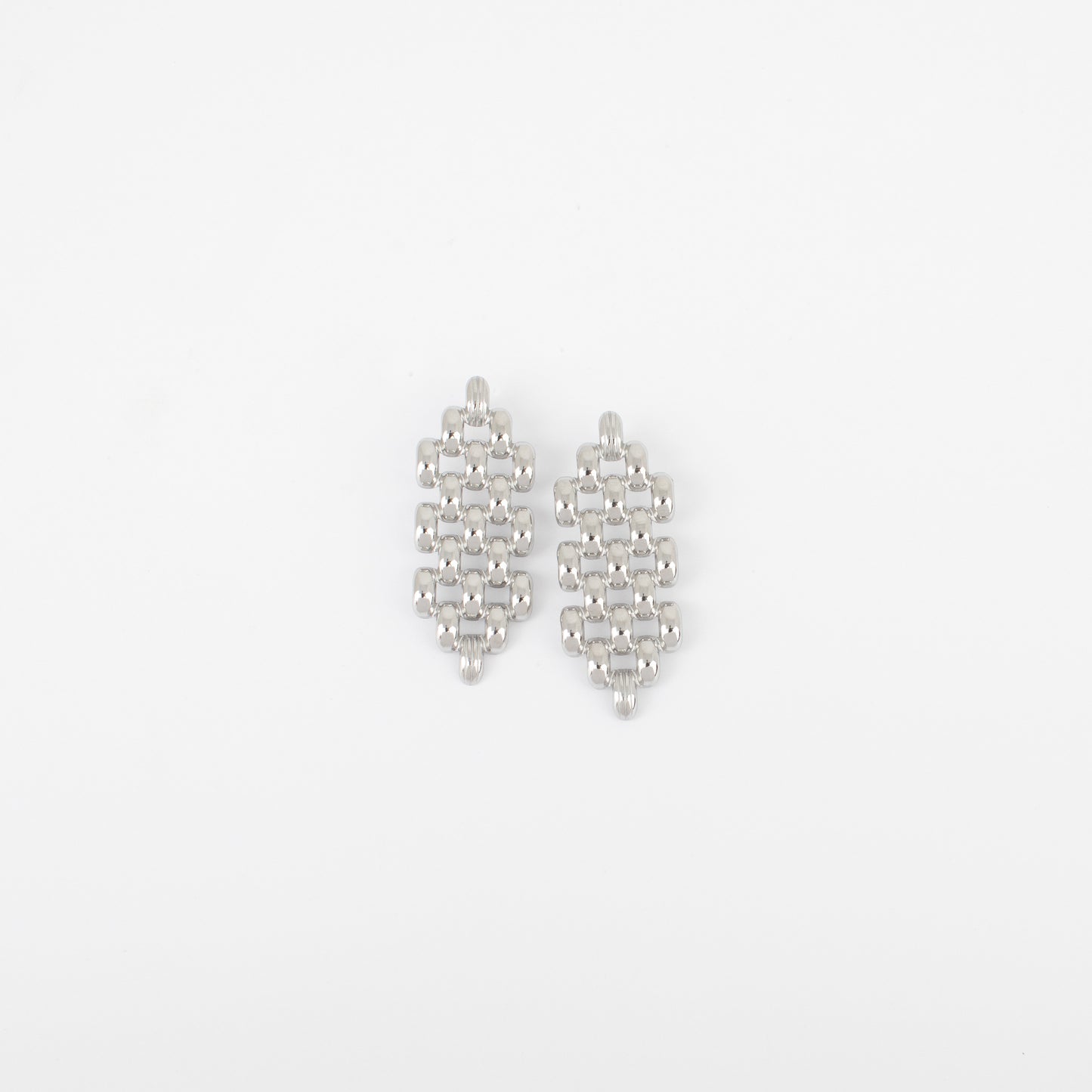 Pair of silver earrings on a light gray background