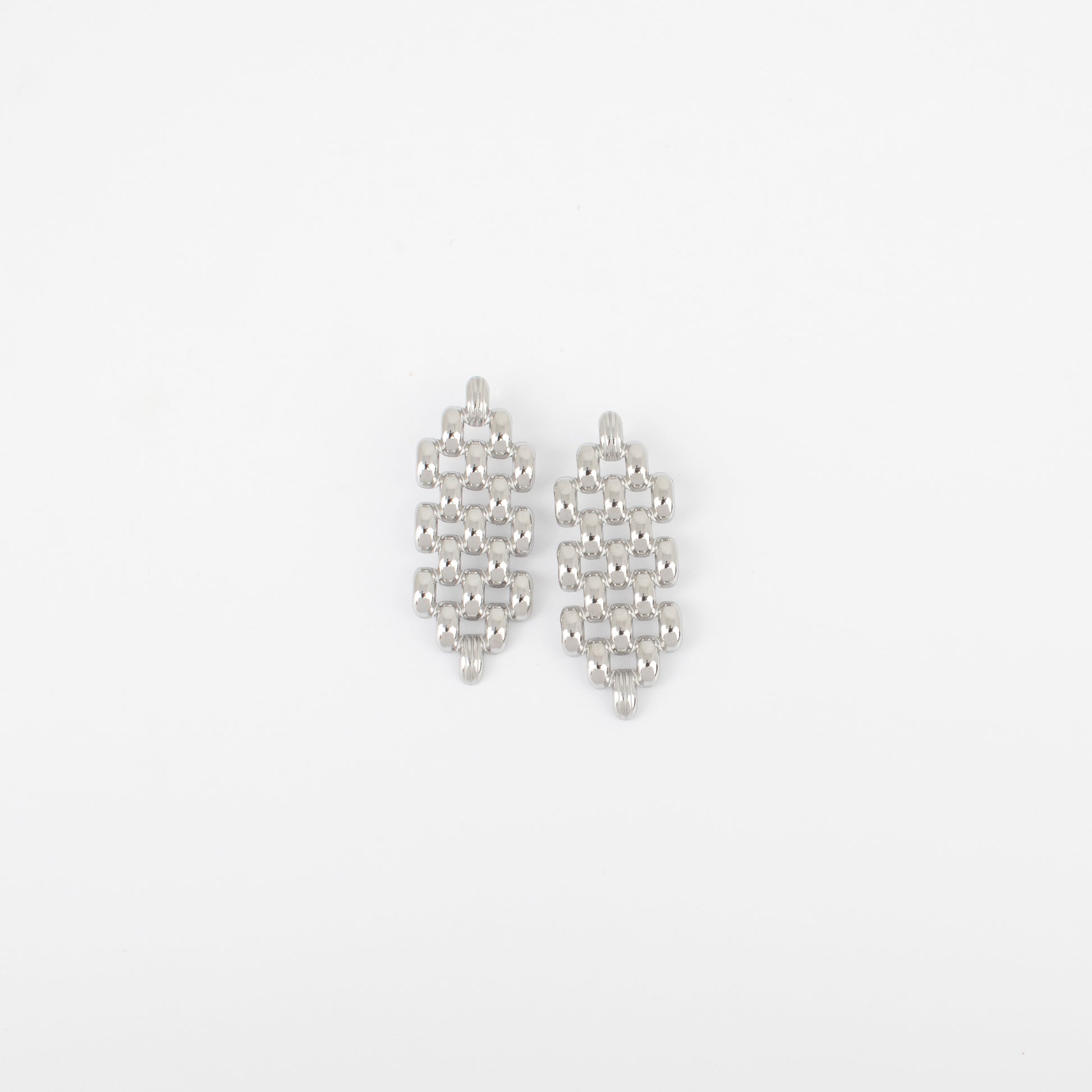Pair of silver earrings on a light gray background