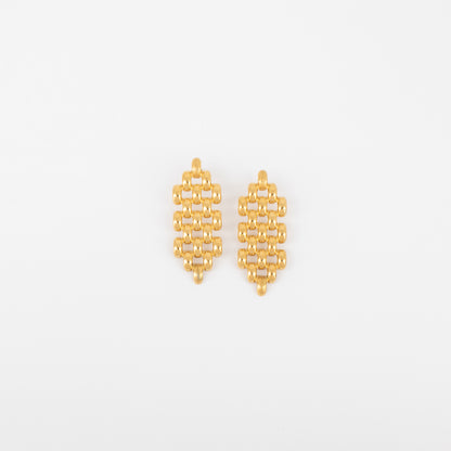 Pair of gold earrings on a light gray background