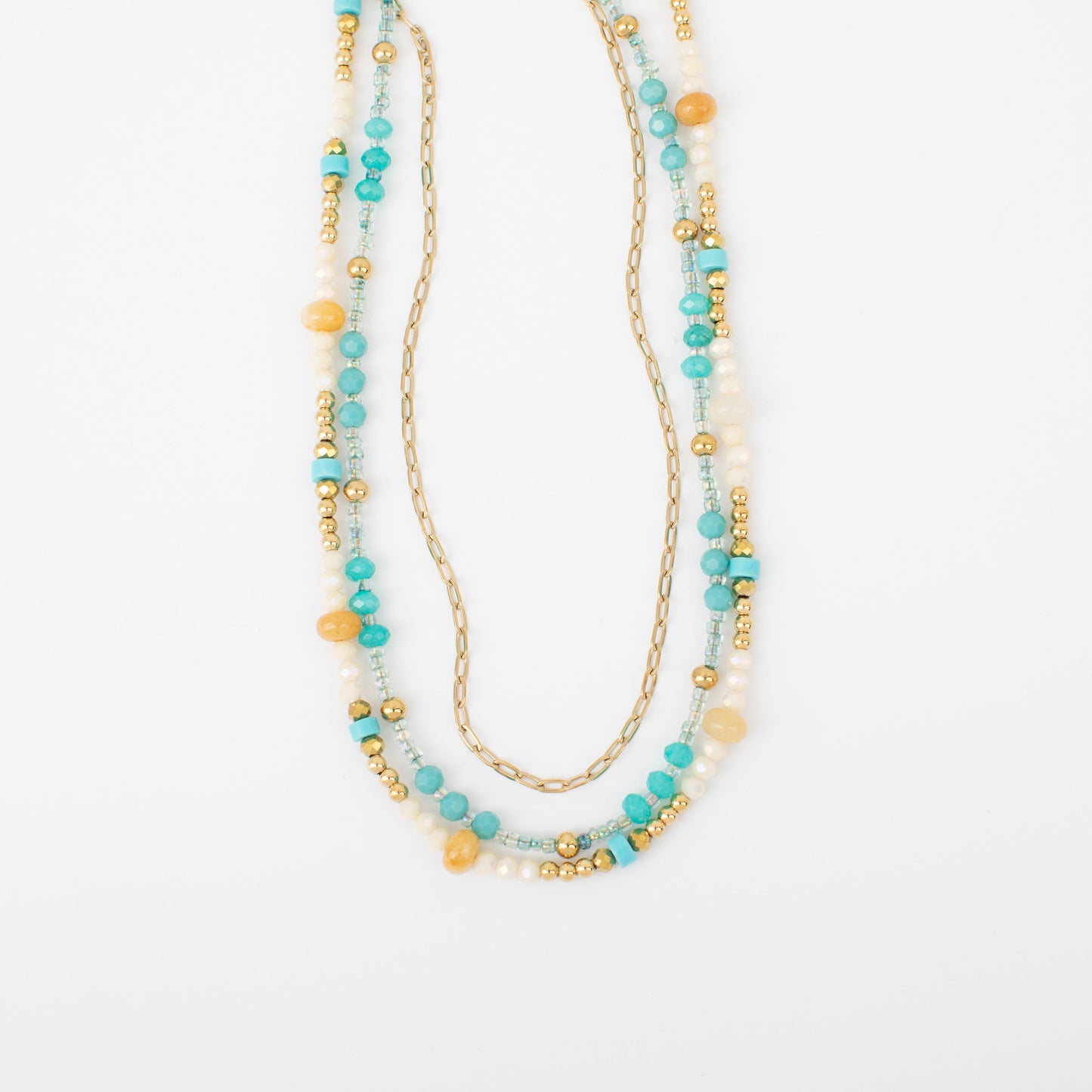 Multistrand beaded necklace with gold chain on a white background