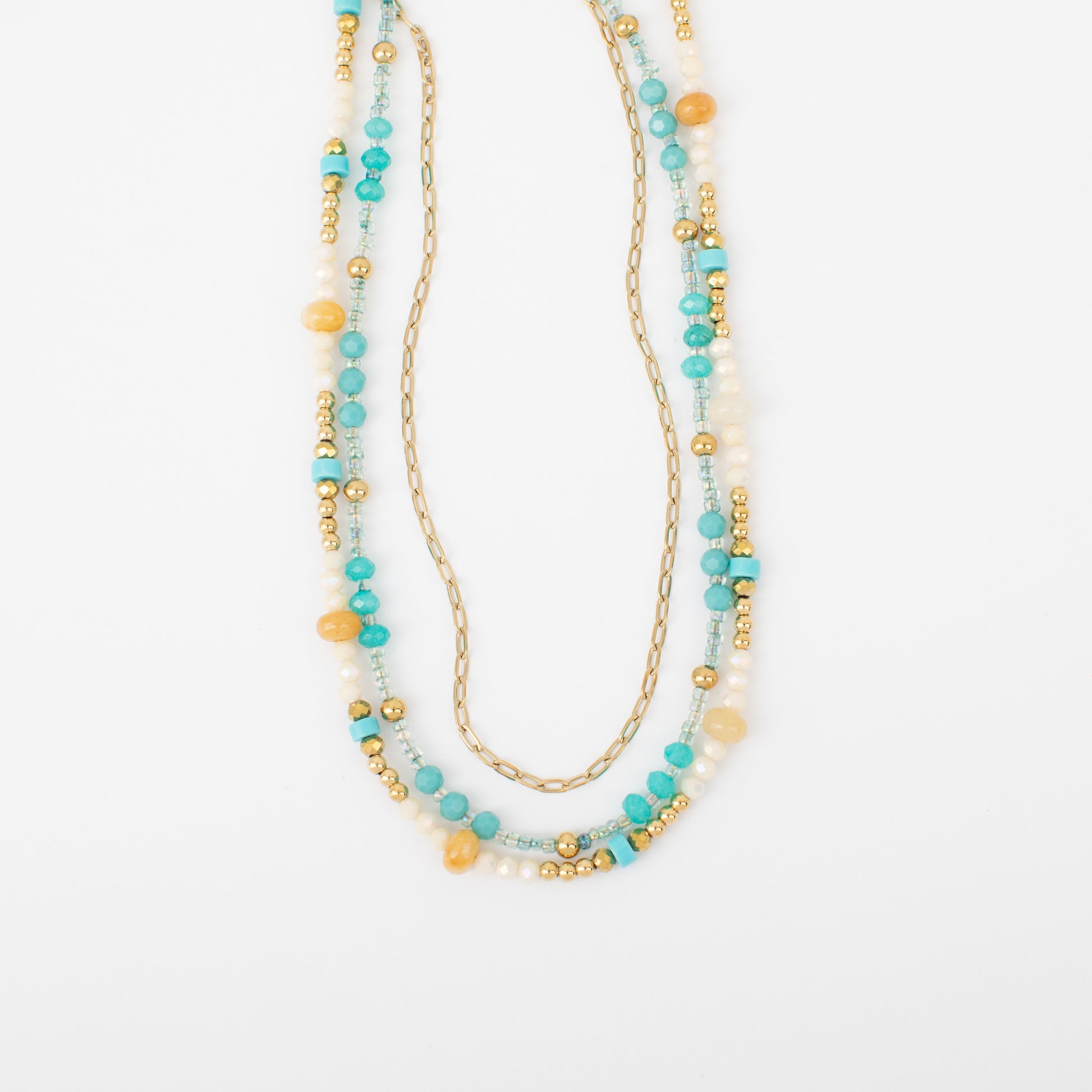 Multistrand beaded necklace with gold chain on a white background