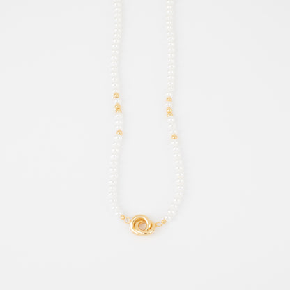 Pearl necklace with a gold clasp on a white background