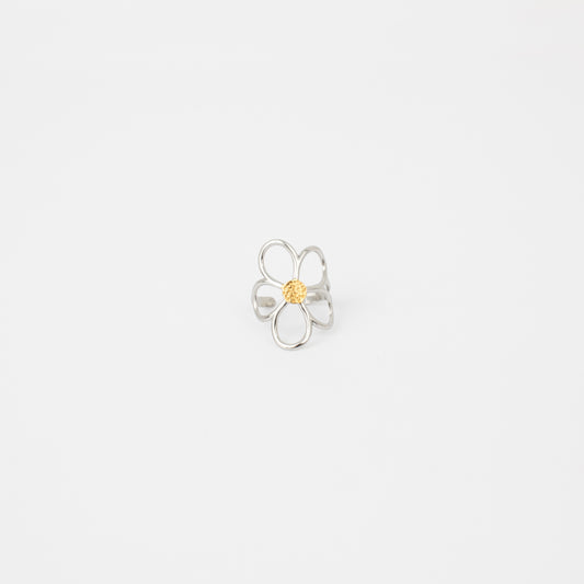 Silver flower-shaped ring with a yellow center on a light gray background