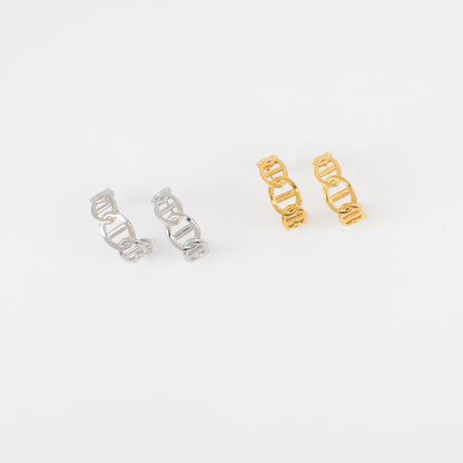 Two pairs of earrings, one silver and one gold, on a white background