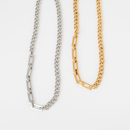 Two chain necklaces, one silver and one gold, on a white background