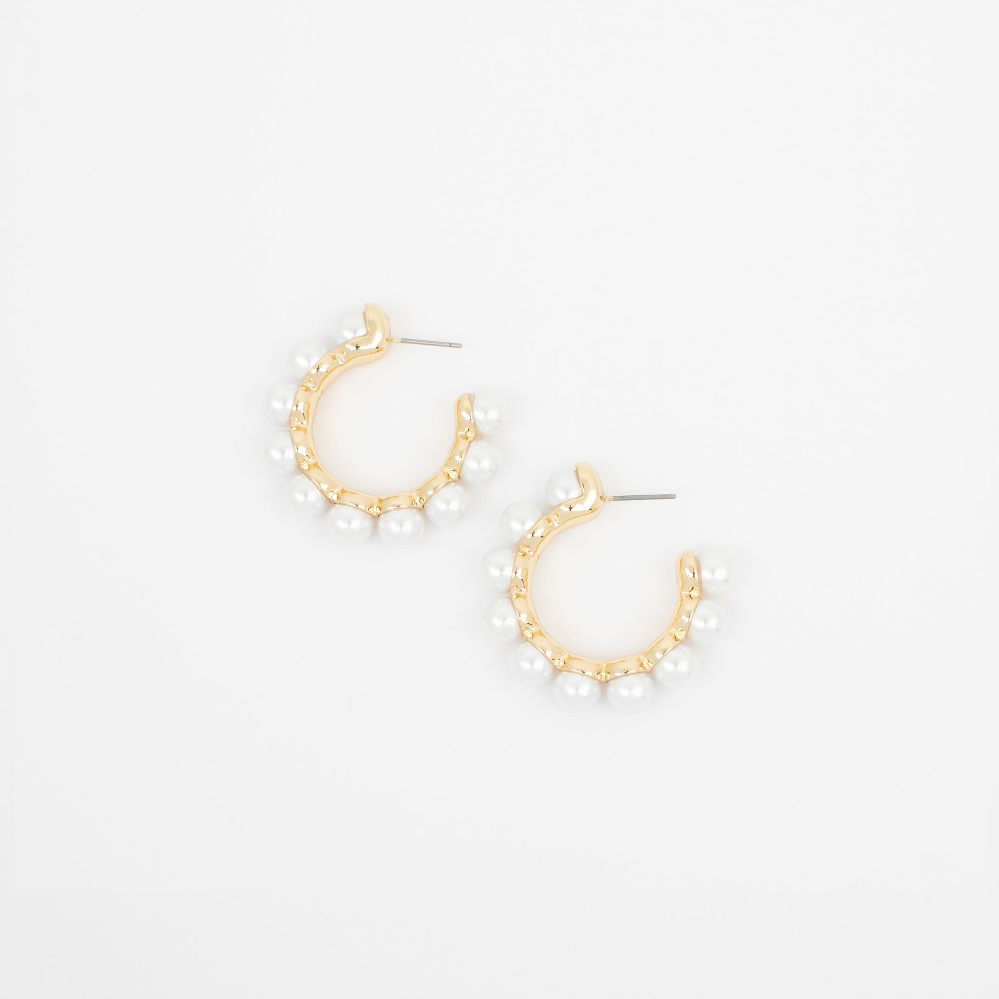 Gold hoop earrings with pearl-like beads on a white background