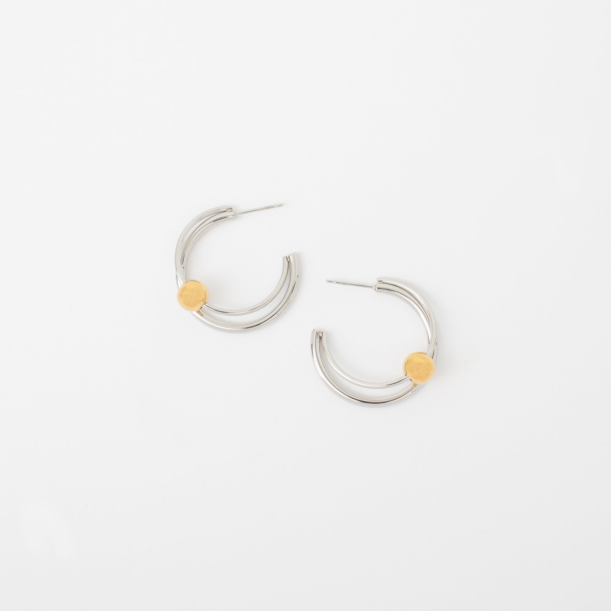 Silver hoop earrings with yellow accents on a white background