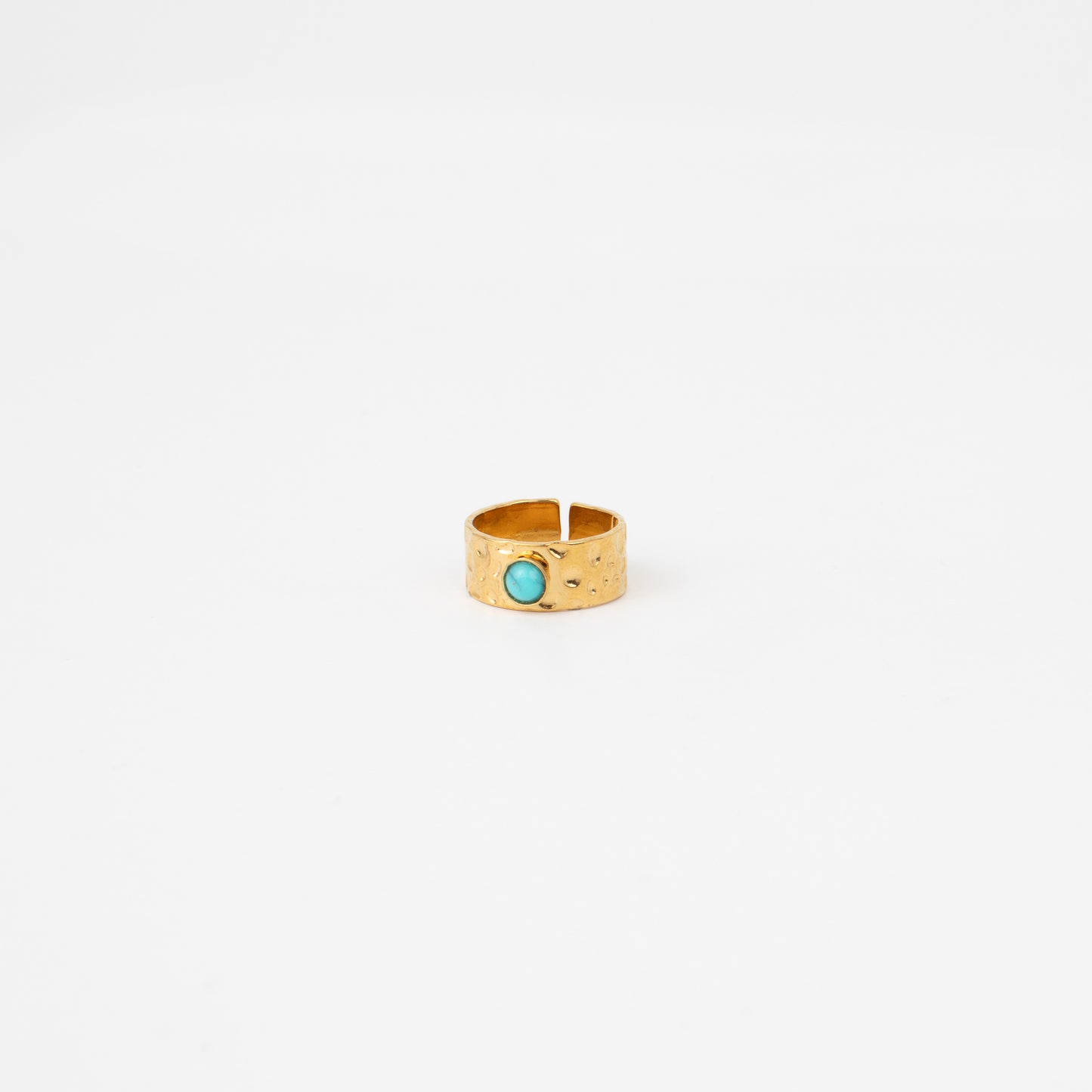 Gold ring with a turquoise stone on a white background