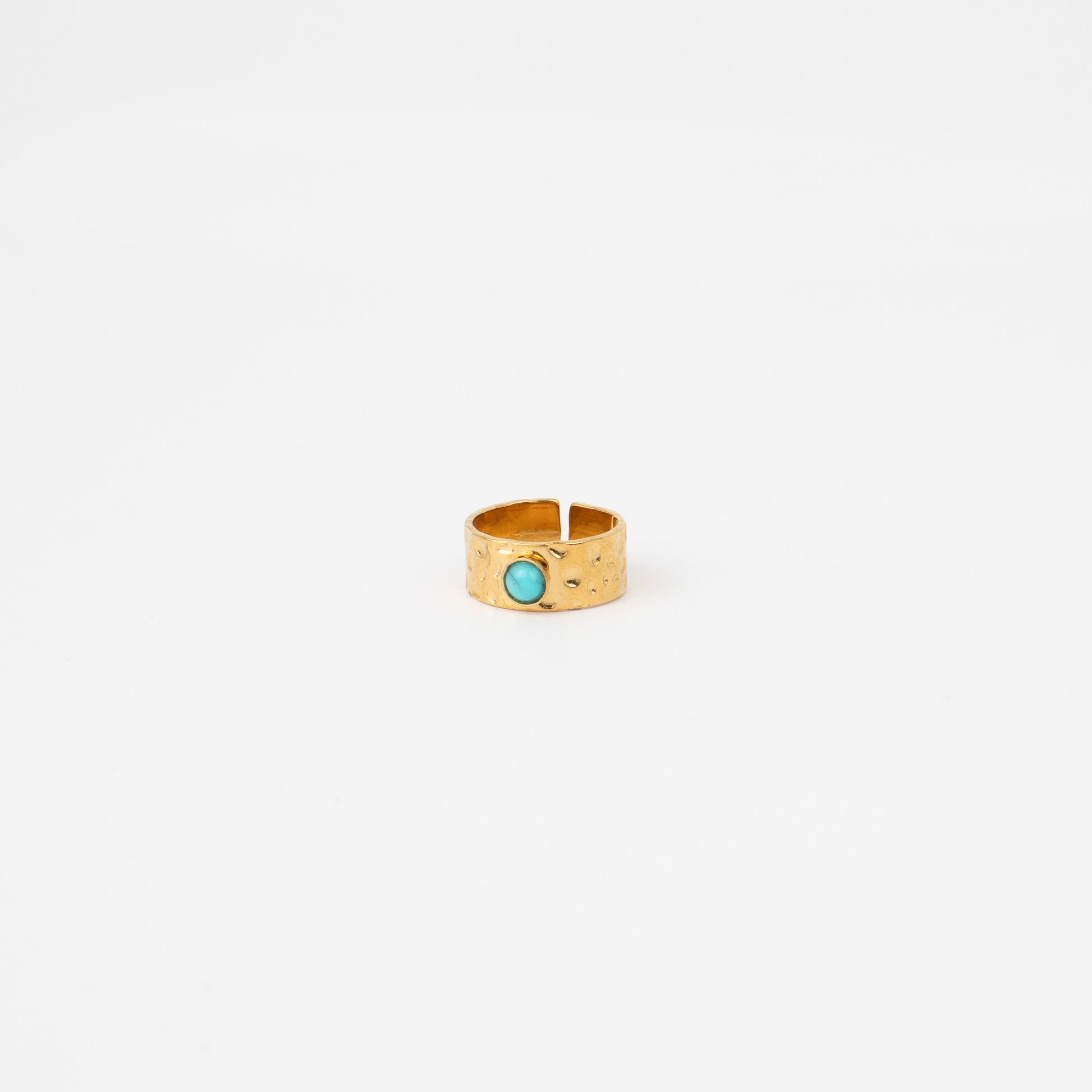 Gold ring with a turquoise stone on a white background
