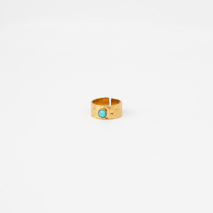 Gold ring with a turquoise stone on a white background