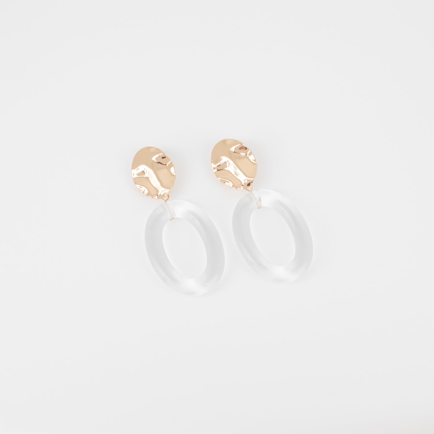 Gold hoop earrings on a light gray background