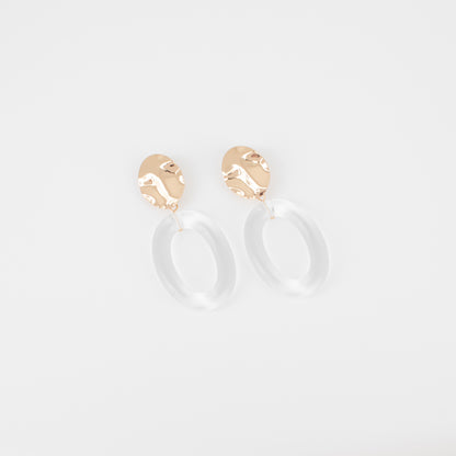 Gold hoop earrings on a light gray background