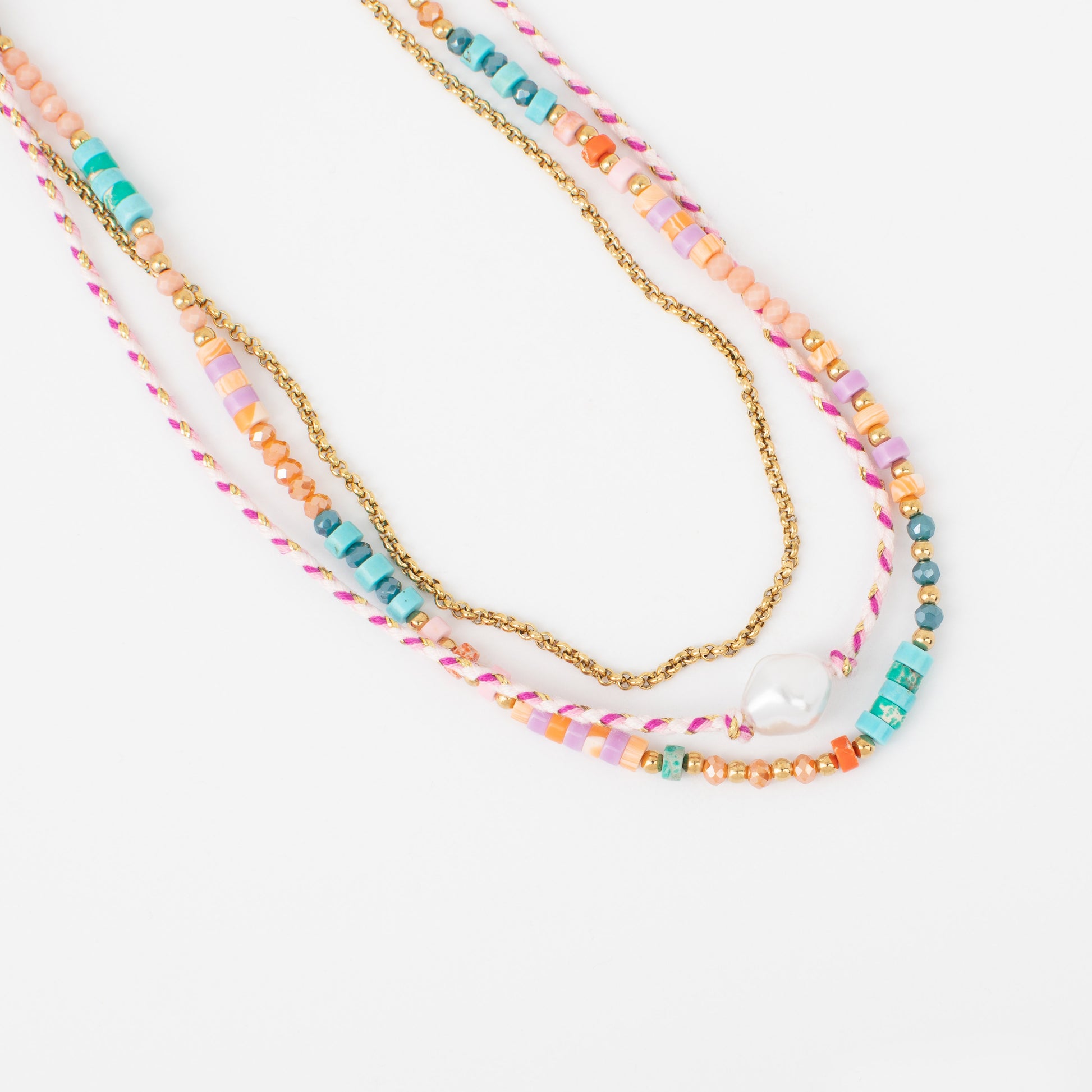 Colorful beaded necklaces with a gold chain on a white background