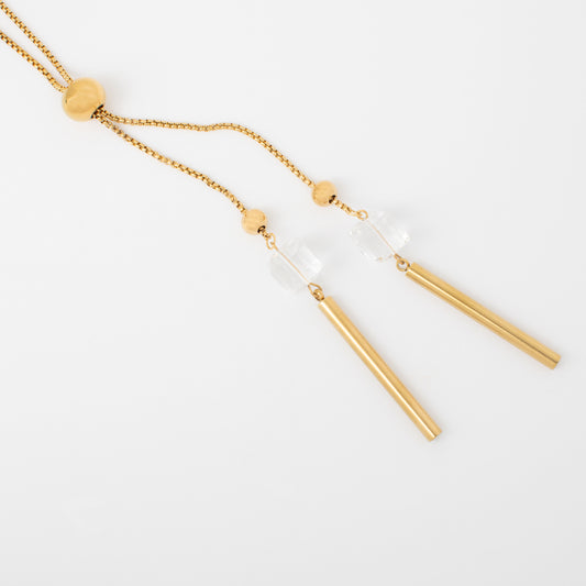 Gold necklace with bar pendants on a white background
