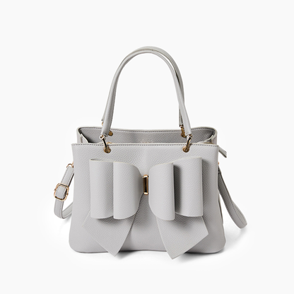 White handbag with bow details on a white background