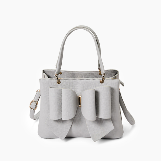 White handbag with bow details on a white background