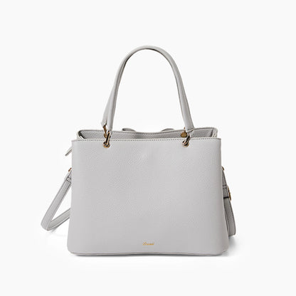 Light gray handbag with gold accents on a white background