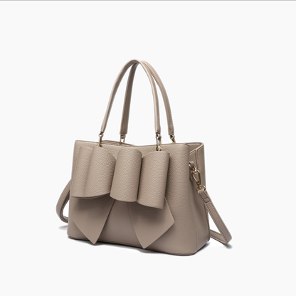 Beige handbag with ruffled details on a white background