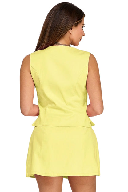 Woman wearing a yellow sleeveless top and skirt set on a white background