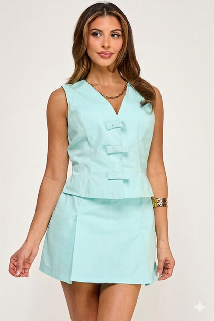 Woman wearing a light blue sleeveless top and skirt set on a white background