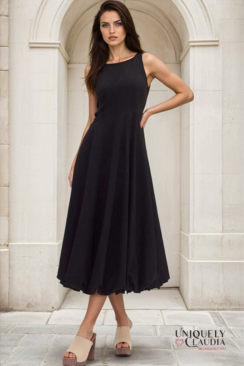 Woman wearing a black dress standing in a marble archway