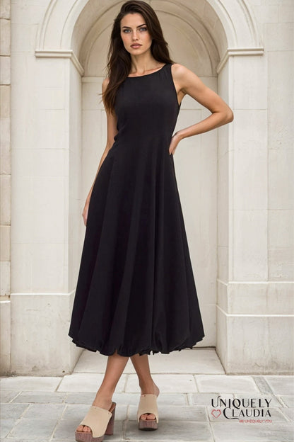 Woman wearing a black dress standing in a marble archway
