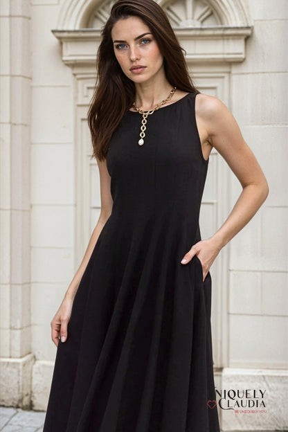 Woman wearing a black dress with a neutral background