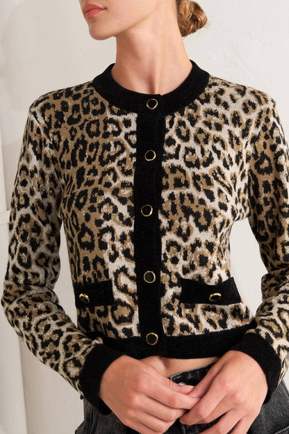 Leopard print jacket with black trim worn by a person against a neutral background