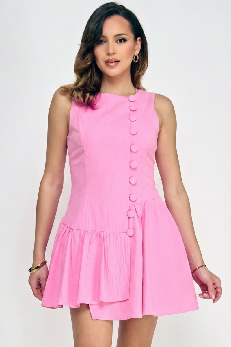 Woman wearing a pink dress with buttons on a white background