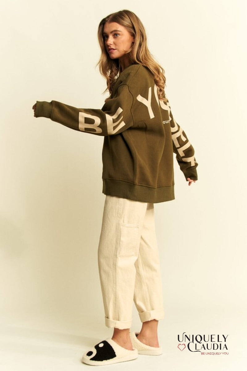 Woman wearing a green sweatshirt and beige pants