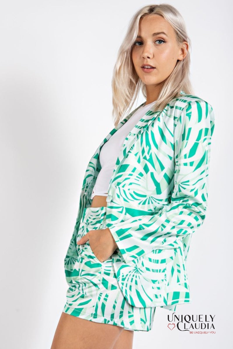 woman wearing green palm print satin blazer