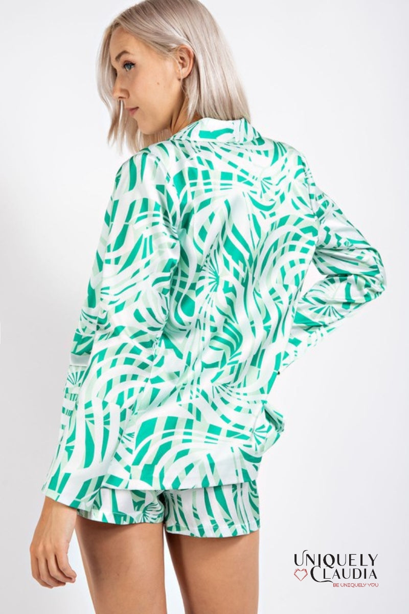 woman wearing green palm print satin blazer