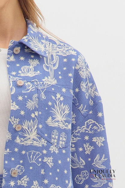 Blue denim jacket with white cactus and desert landscape pattern on a white background