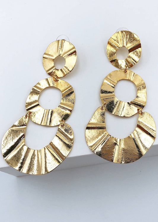 Gold earrings on a white background