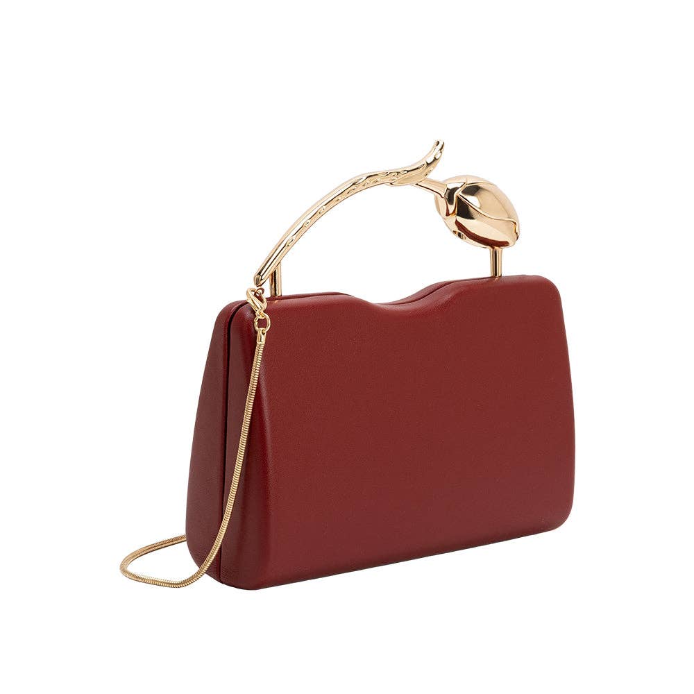 A burgundy leather clutch handbag with a curved gold-tone handle shaped like a stylized leaf and a matching gold chain strap, shown on a plain white background.