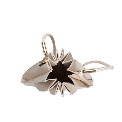 Beige handbag with star-shaped design on a white background