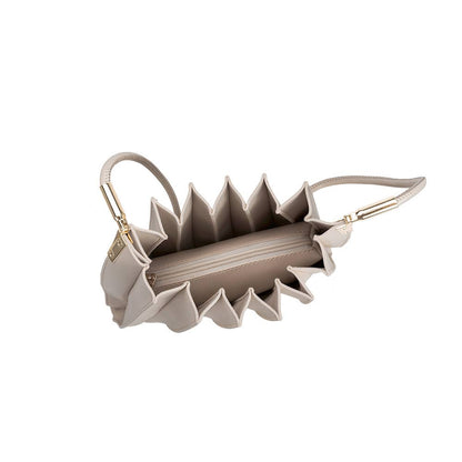 Beige handbag with unique design on a white background