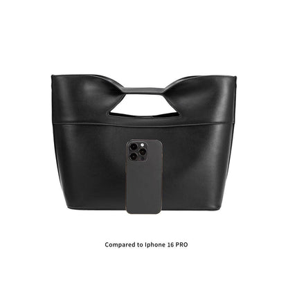 Black handbag with a phone case attached on a white background