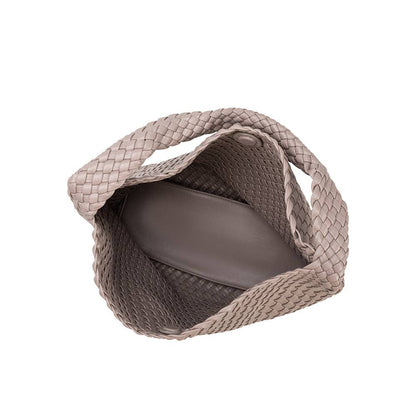 Woven pet carrier with a plain background