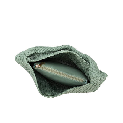 Green woven pouch with a smaller green pouch inside on a white background