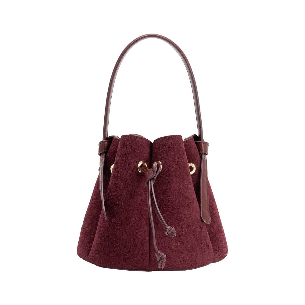 A burgundy suede bucket bag with a single shoulder strap, drawstring closure, and gold-tone hardware, shown against a plain white background.