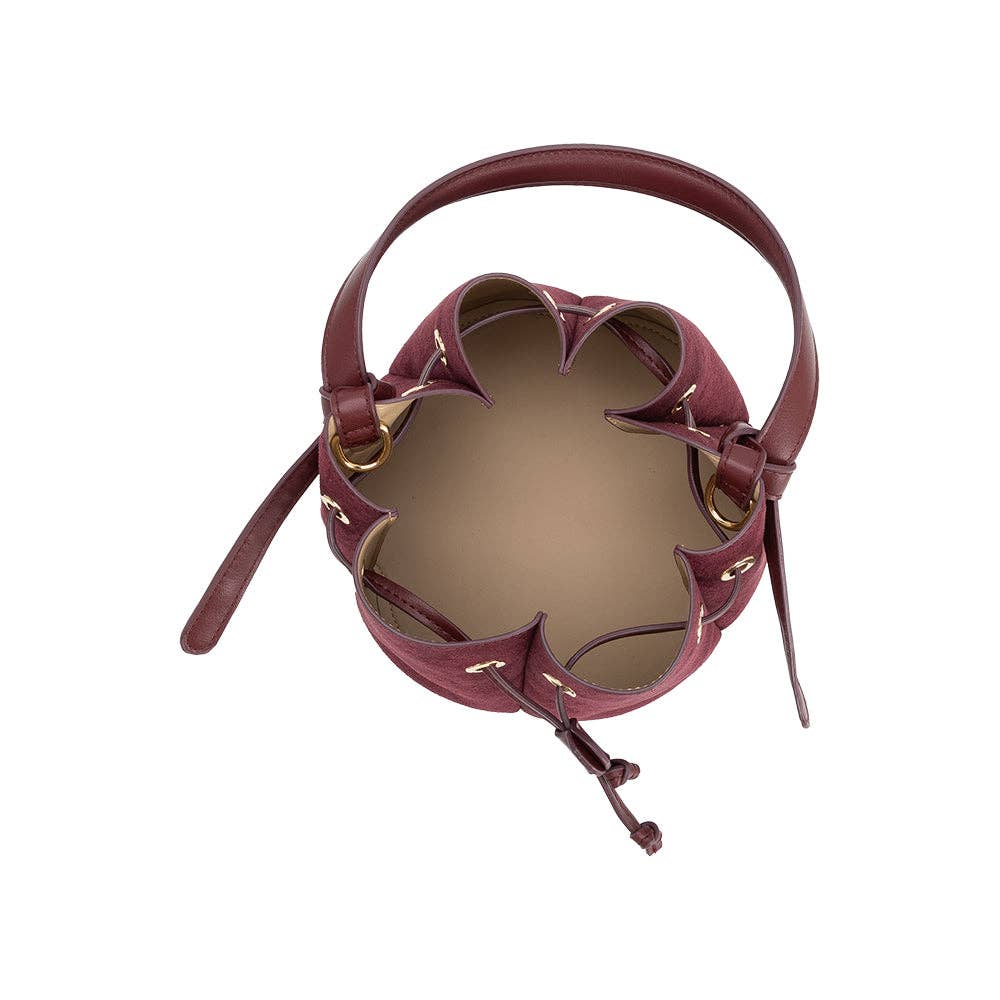 Maroon leather handbag with unique design on a white background