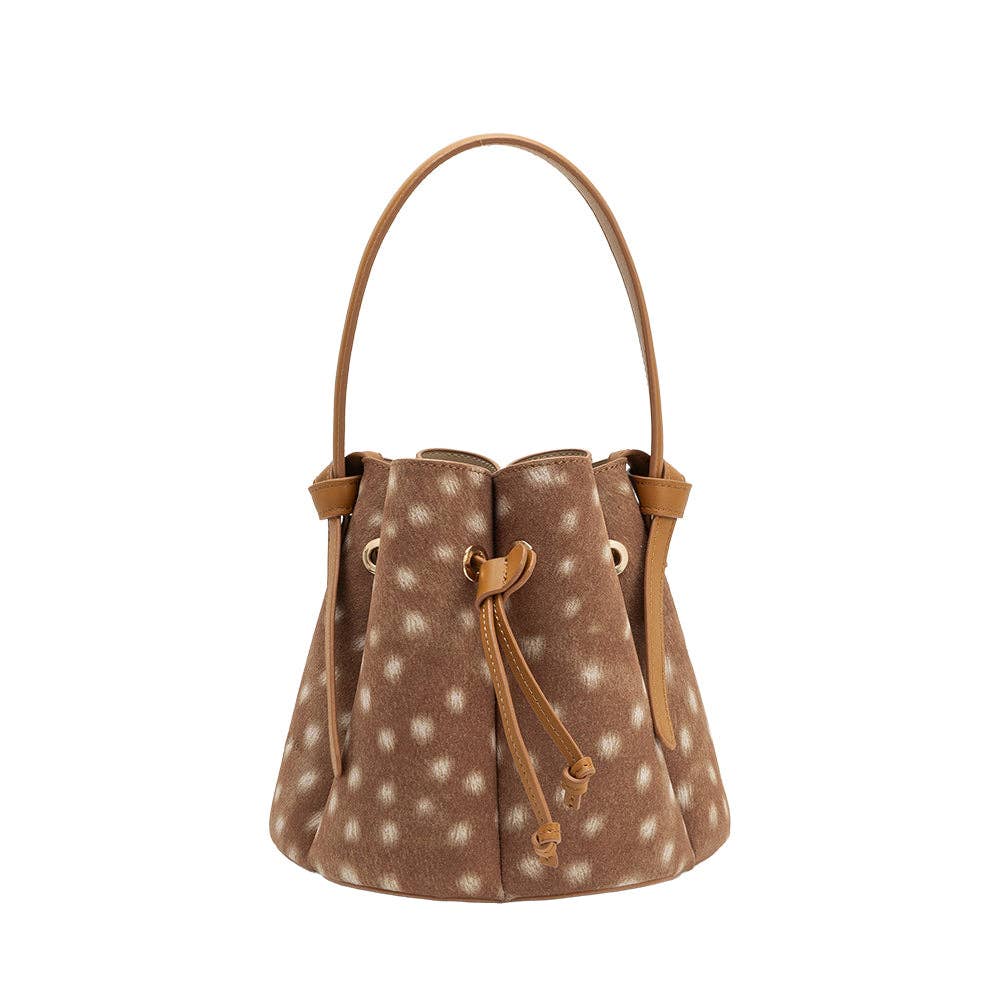 A brown faux-hide bucket bag with white spots, tan leather trim, and a single top handle, shown against a plain white background.