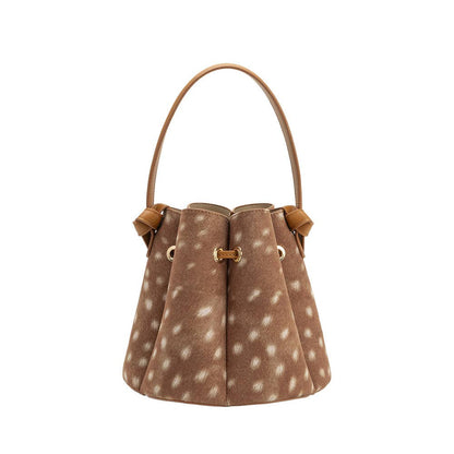 Brown fawn print handbag with leather accents on a white background