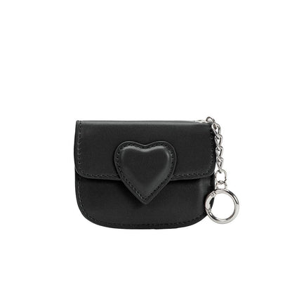 Black pouch with heart-shaped design and chain on a white background