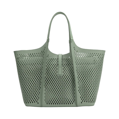 Perforated green handbag on a white background