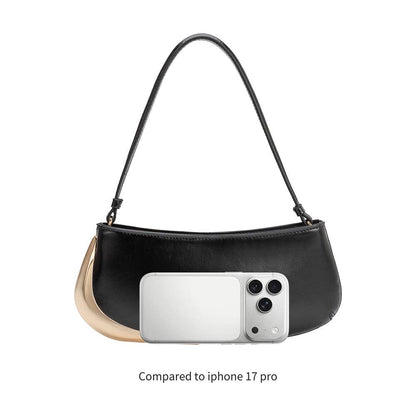 Black handbag with a phone inside, compared to an iPhone 17 Pro on a white background