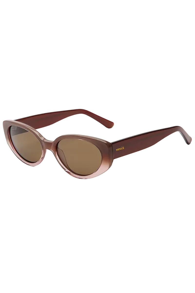 Oval sunglasses with a translucent brown gradient frame and brown tinted lenses, shown on a plain white background.