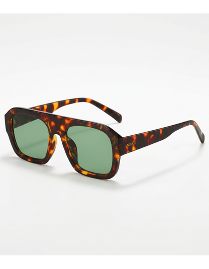 Sunglasses with tortoiseshell frame and green lenses on a white background